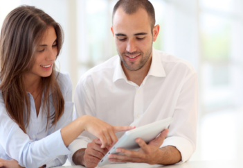 young couple going over finances on paper