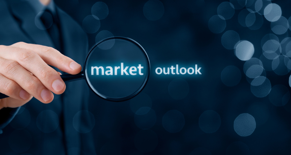 Businessman's hand holding magnifying glass to market outlook